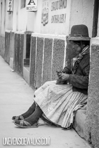 Lady Sitting on Curb in Tupiza Chewing Coca Leaves